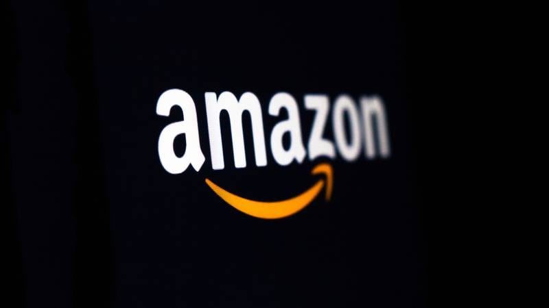 Amazon logo on the screen. Amazon is an American multinational technology company  which focuses on e-commerce, cloud computing, digital streaming, and artificial intelligence.